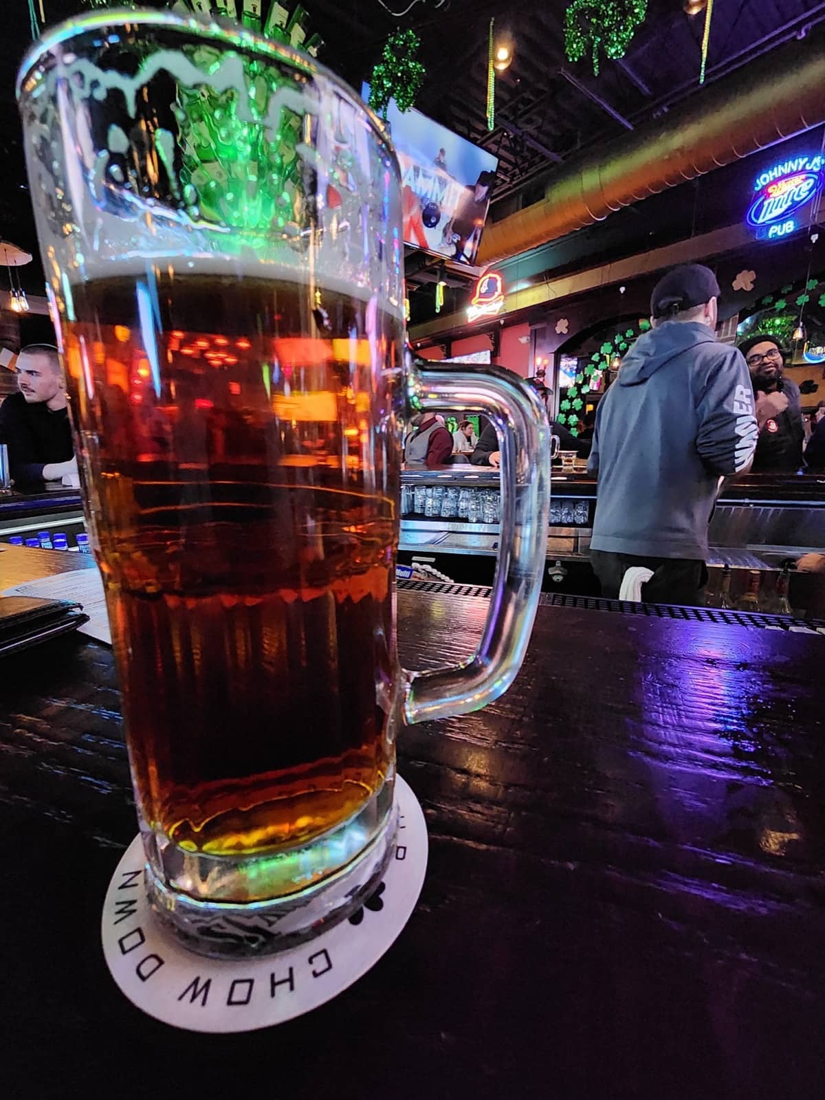 A pint at the bar at Johnny J's, screens on